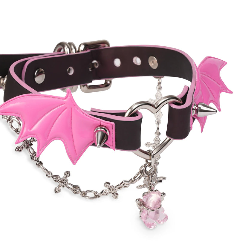 QIYE_Leather_Sweetheart_Devil_Collar_Choker: A fashionable choker featuring a black and pink gradient leather strap, metallic hardware, pink bat - wing accents with spikes, a silver chain, and a pink crystal charm.