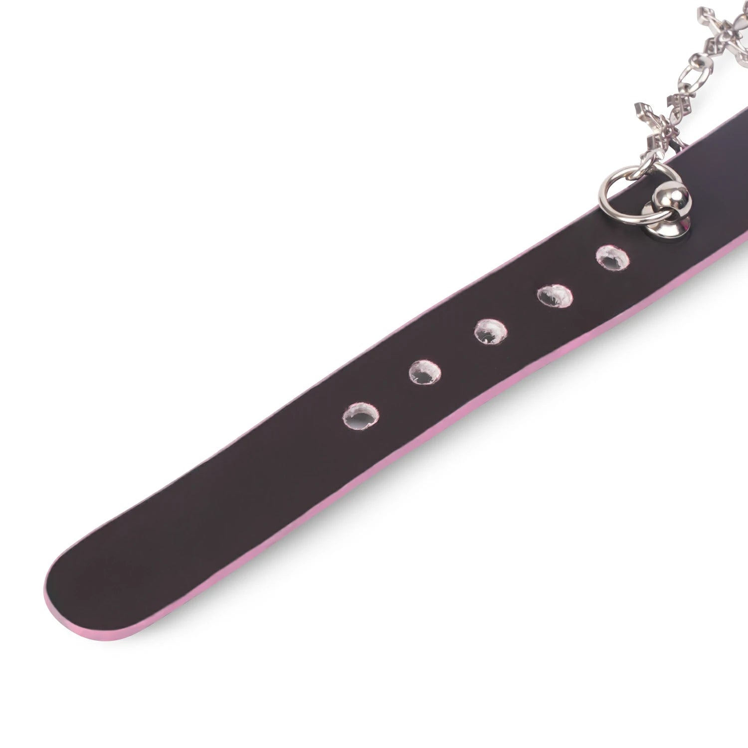 QIYE_Leather_Sweetheart_Devil_Collar_Choker: A detailed view of the choker strap, featuring black material with pink edging and metallic eyelets, along with a portion of the attached chain.