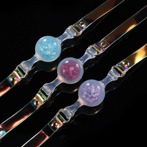 Foam_Handmade_Soft_Silicone_BDSM_Ball_Gag: Handmade BDSM ball gags (sex gags) crafted from soft silicone, showcasing iridescent straps and three shimmering color variants (blue, red, purple), blending artisanal design for kink play.