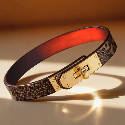 Black embossed leather choker with red heat-reacitve interior leather, featuring a polished gold turn-lock buckle