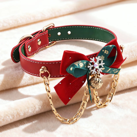 Red and green leather Christmas choker with a double bow, featuring a silver snowflake charm, gold jingle bell, and decorative gold chains