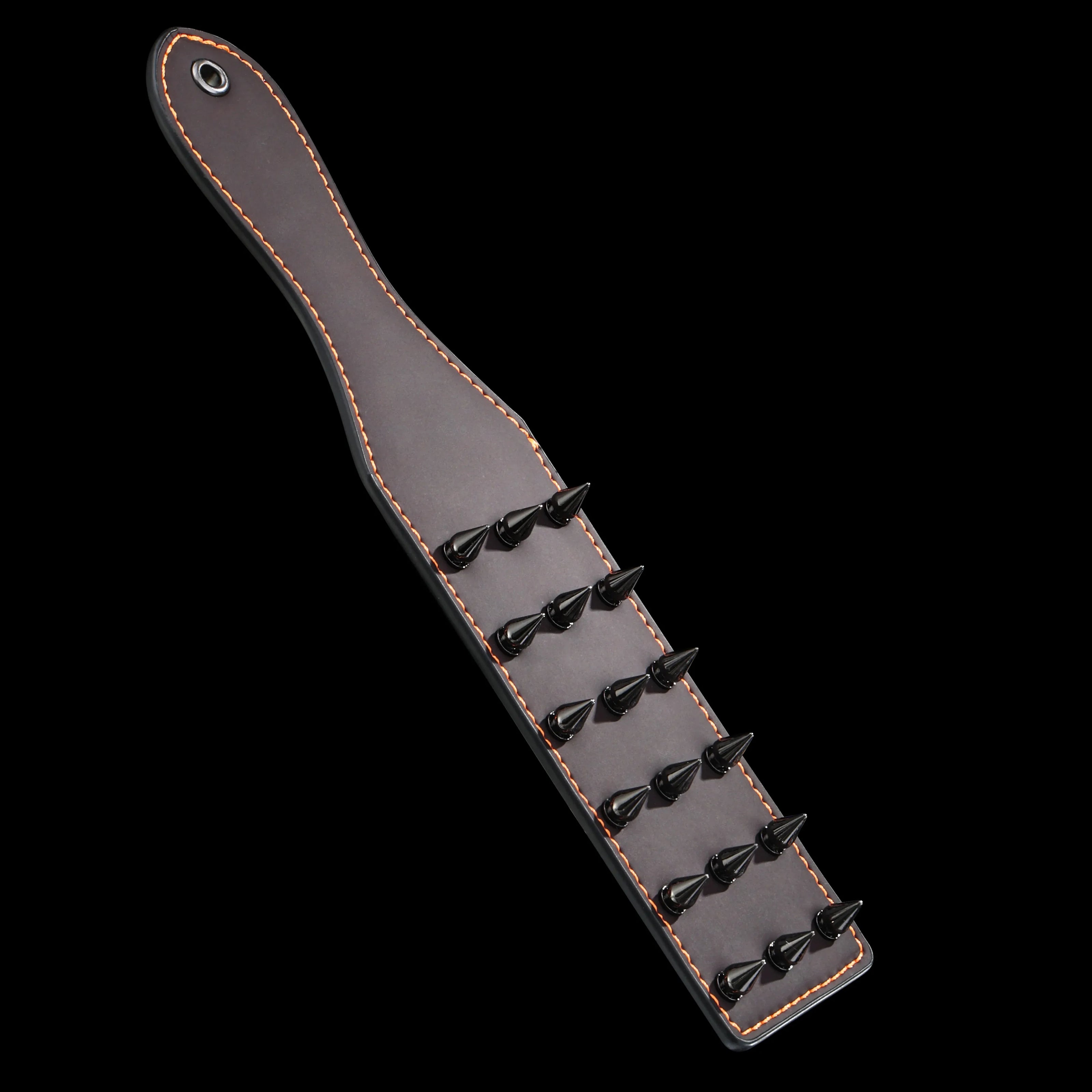 Red heat-reactive leather spanking paddle featuring sharp black metal cone spikes and orange contrast stitching