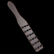 Red heat-reactive leather spanking paddle featuring sharp black metal cone spikes and orange contrast stitching
