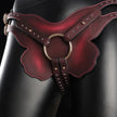 Large pink heat-reactive leather butterfly wing strap-on harness with gold O-rings, featuring multiple studded straps and pink contrast stitching