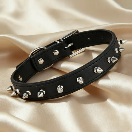 Black leather punk choker with silver metal cone spikes and an adjustable silver buckle on a silk background