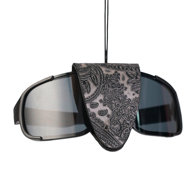 QIYE_Leather_Eye_Clamp_Rhythm_Paddle_Heat_Reactive: Handmade BDSM glasses clip. Doubles as wearable necklace, made of heat - reactive, color - changing leather, blending artisanal kink - play style, shown clipped on glasses.