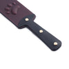 「Holy Seal」Handmade Color - changing Leather Paddle: Handmade BDSM paw print paddle. Crafted from heat - reactive, color - changing leather. Showing the detail of the paddle handshake.Features dual embossed surfaces (paw prints & gothic crosses) for varied impact play, blending artisanal design with heavier impact power.