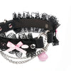 QIYE_Leather_Lilith_Collar_Choker_Heat_Reactive: Side view of the choker, featuring black lace, pink bows, metallic chains, a pink bell, and a heart - shaped metal ring. 